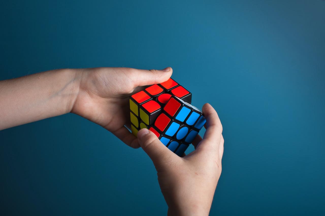 A Rubik's Cube being solved by two hands